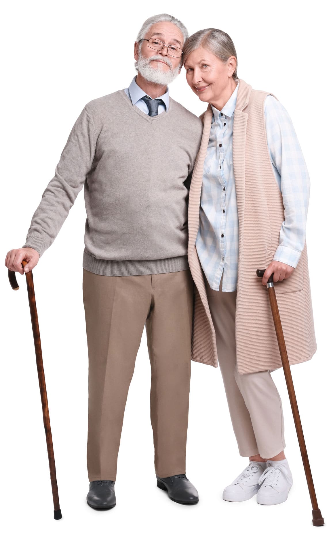 An elderly man and woman stand close together, both using wooden canes for support. The man has a grey beard and wears glasses; the woman has short grey hair and a long sleeveless sweater, exemplifying the need for thoughtful senior living care options.